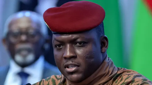 Portrait d'Ibrahim Traoré, chef de l'État du Burkina Faso, en tenue militaire beige et béret rouge